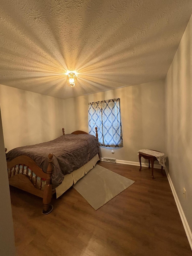 102 Locust St, Manchester, KY 40962 - bedroom with baseboards, wood finished floors, a textured ceiling, and visible vents