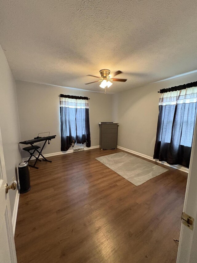 102 Locust St, Manchester, KY 40962 - unfurnished room with baseboards, a ceiling fan, wood finished floors, and a textured ceiling