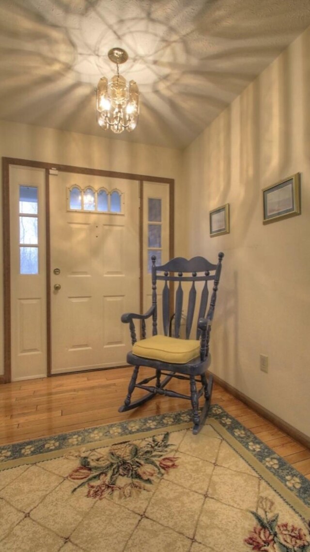 102 Locust St, Manchester, KY 40962 - entrance foyer featuring light wood-type flooring, baseboards, and a chandelier