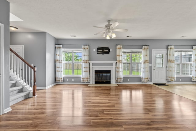 533 Lanarkshire Pl, Lexington, KY 40509 - unfurnished living room with wood finished floors, ceiling fan, baseboards, and a textured ceiling
