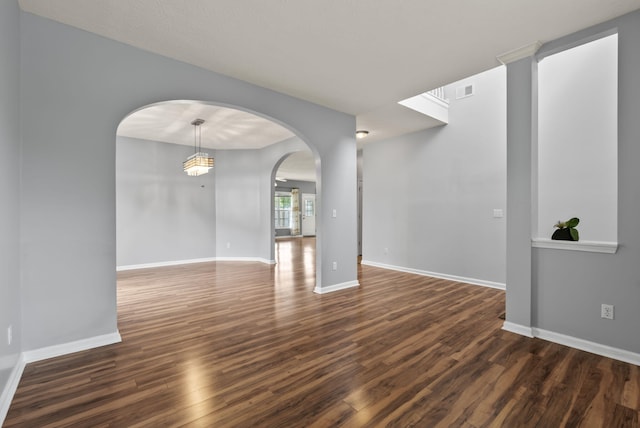 533 Lanarkshire Pl, Lexington, KY 40509 - unfurnished room featuring arched walkways, dark wood finished floors, and baseboards