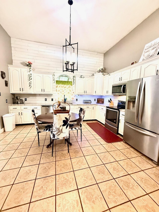 88 Powell Rd, Mckee, KY 40447 - kitchen with appliances with stainless steel finishes, a chandelier, pendant lighting, white cabinetry, and light tile patterned floors