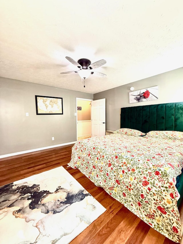 88 Powell Rd, Mckee, KY 40447 - bedroom featuring wood finished floors, baseboards, a ceiling fan, and a textured ceiling