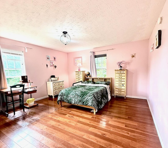 88 Powell Rd, Mckee, KY 40447 - bedroom featuring hardwood / wood-style flooring, a textured ceiling, multiple windows, and baseboards