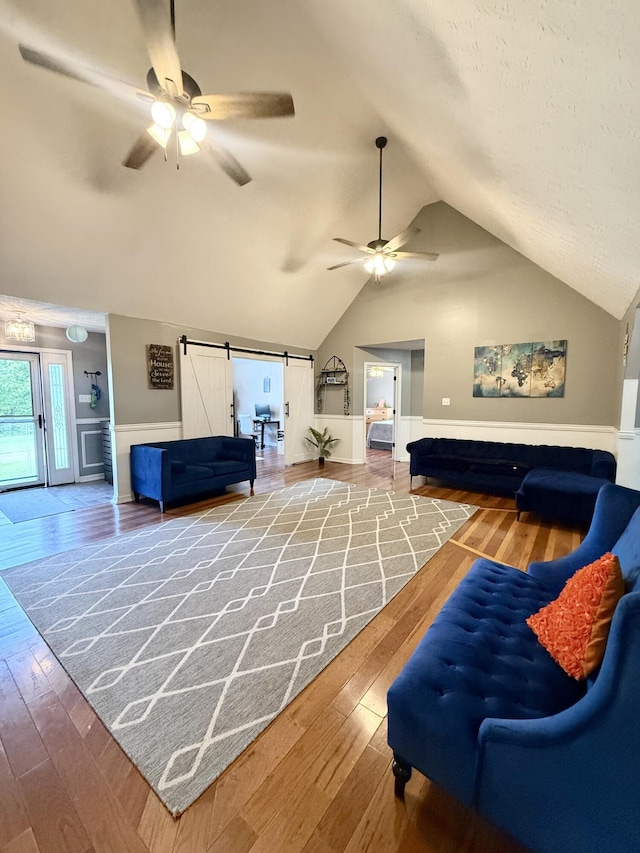 88 Powell Rd, Mckee, KY 40447 - living area featuring ceiling fan, hardwood / wood-style floors, vaulted ceiling, and a barn door