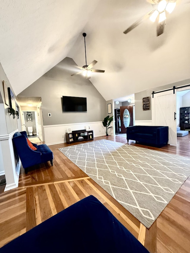 88 Powell Rd, Mckee, KY 40447 - living room with a ceiling fan, wood finished floors, a barn door, lofted ceiling, and baseboards