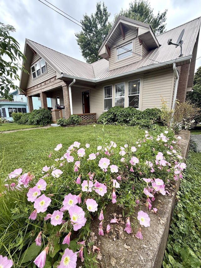 204 Cotter Ave, Somerset, KY 42501 - view of front of home with metal roof, a front lawn, covered porch, and brick siding