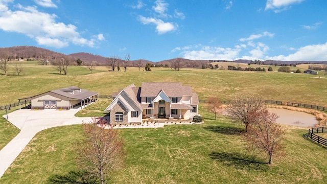 drone / aerial view featuring a rural view and a mountain view