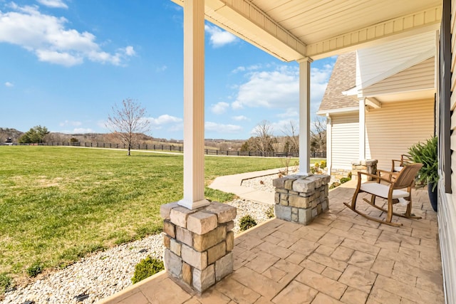 view of patio / terrace with a rural view and covered porch