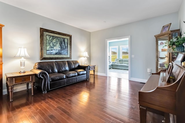 living room with baseboards and wood finished floors