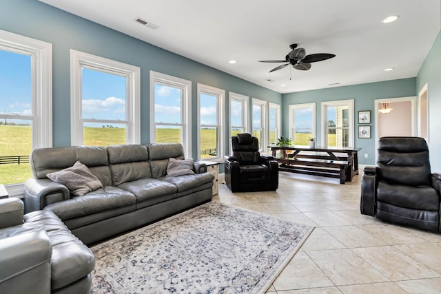 living area with light tile patterned floors, visible vents, recessed lighting, and ceiling fan