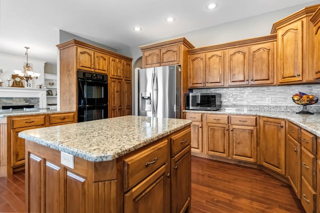 kitchen featuring stainless steel appliances, a kitchen island, tasteful backsplash, and dark wood finished floors