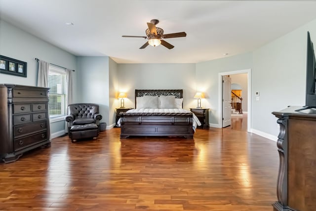 bedroom with baseboards, a ceiling fan, and wood finished floors