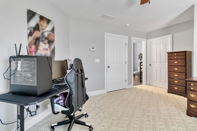 carpeted home office featuring baseboards and a ceiling fan