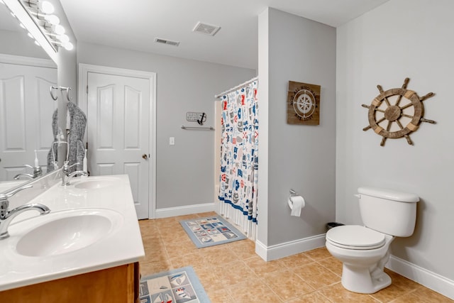 bathroom featuring visible vents, tile patterned flooring, baseboards, and a sink