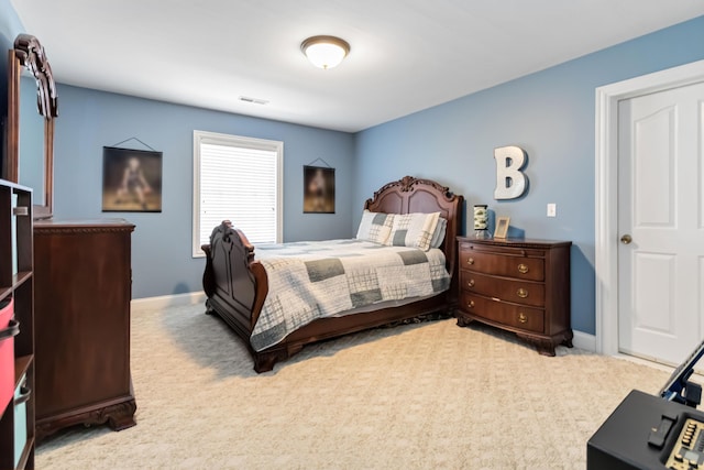 carpeted bedroom with baseboards and visible vents