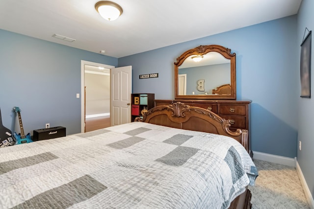 bedroom with carpet floors, visible vents, and baseboards
