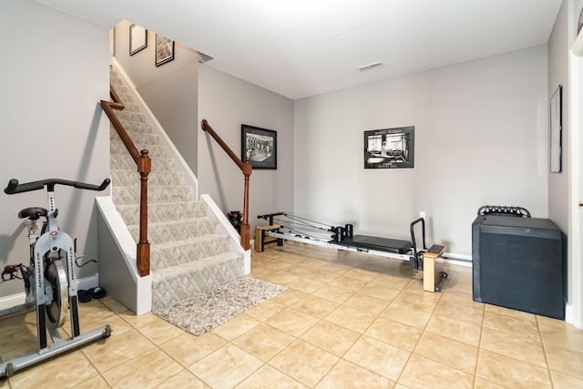 workout area featuring visible vents and light tile patterned floors