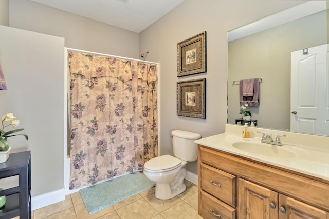 full bath with toilet, vanity, tile patterned floors, and baseboards