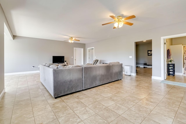 living room with a ceiling fan, baseboards, and light tile patterned flooring
