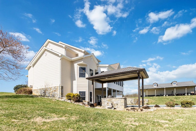 view of side of home featuring a gazebo and a yard