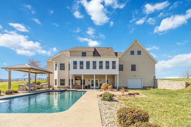 rear view of house featuring a gazebo, a yard, a fenced in pool, and a patio
