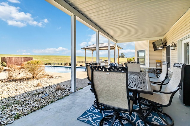 view of patio / terrace featuring a gazebo, outdoor dining space, and a fenced in pool