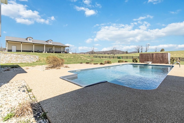 view of swimming pool featuring a yard, a fenced in pool, and fence
