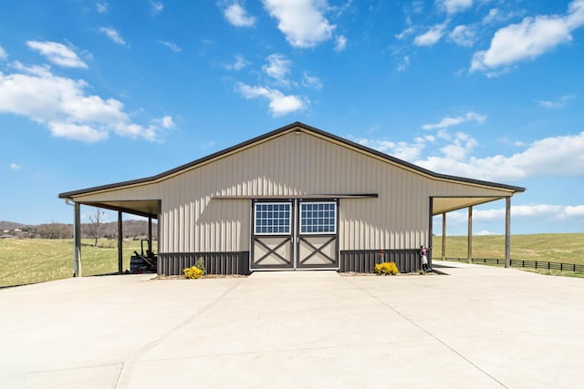 garage with fence and a detached garage