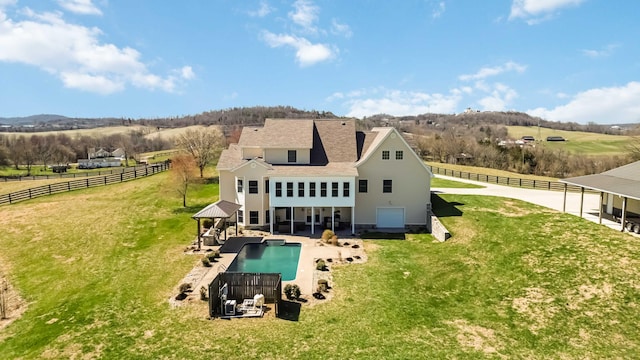 back of property featuring a gazebo, a yard, and fence