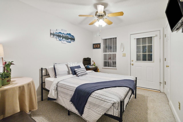 carpeted bedroom with ceiling fan and baseboards