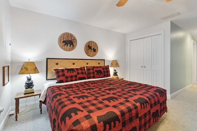 bedroom with baseboards, carpet flooring, visible vents, and a closet