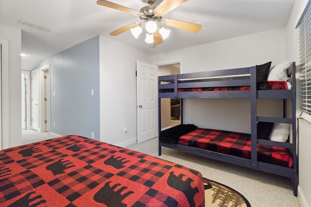 carpeted bedroom with visible vents, baseboards, and ceiling fan