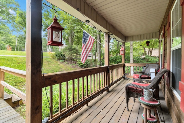 wooden deck with a lawn