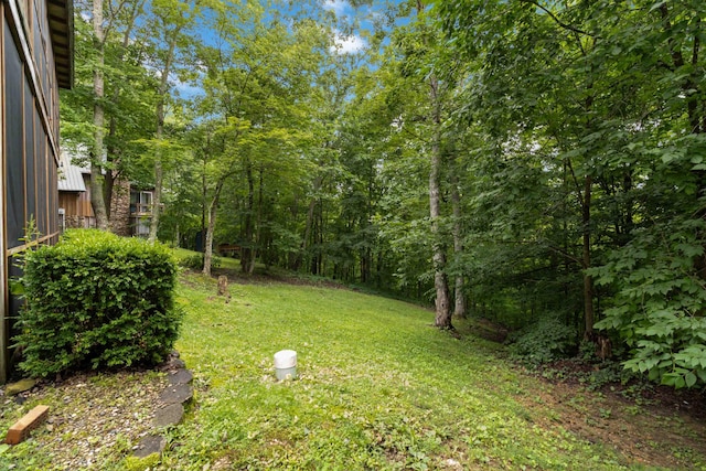 view of yard with a view of trees