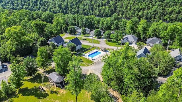 birds eye view of property featuring a view of trees