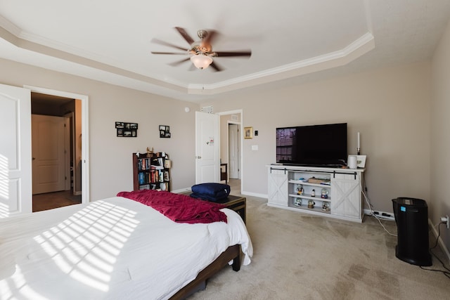carpeted bedroom with baseboards, ornamental molding, a raised ceiling, and ceiling fan