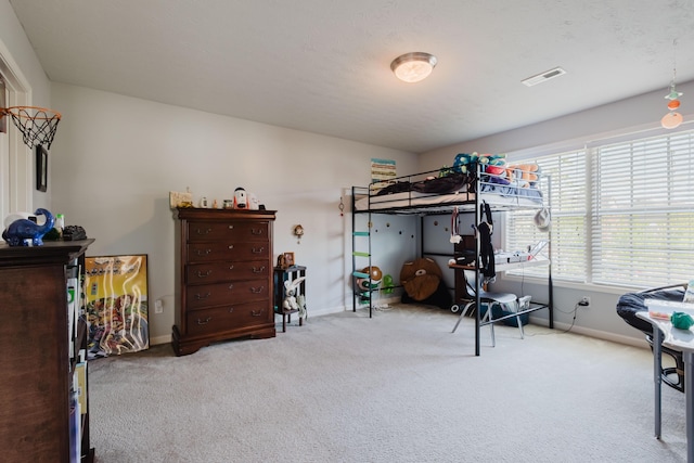 carpeted bedroom featuring baseboards and visible vents