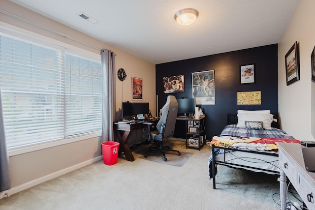 carpeted bedroom with baseboards, visible vents, and multiple windows