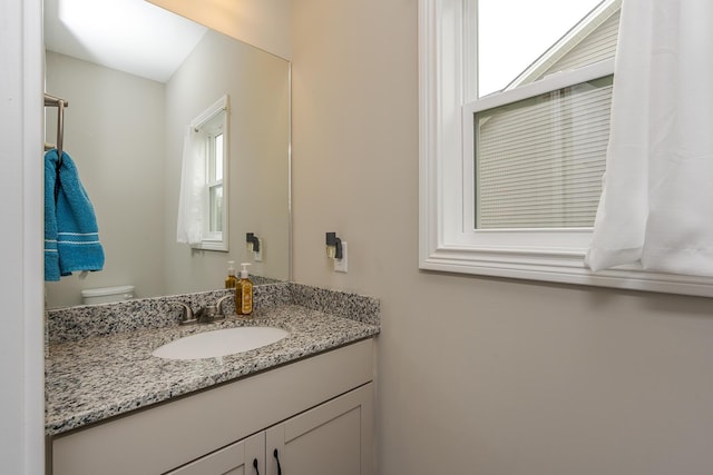 bathroom featuring vanity and toilet