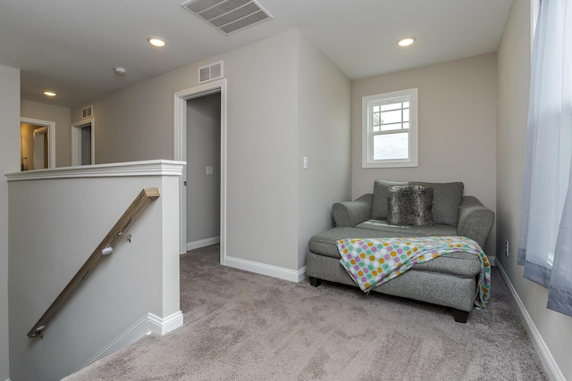 sitting room featuring baseboards, recessed lighting, visible vents, carpet, and an upstairs landing