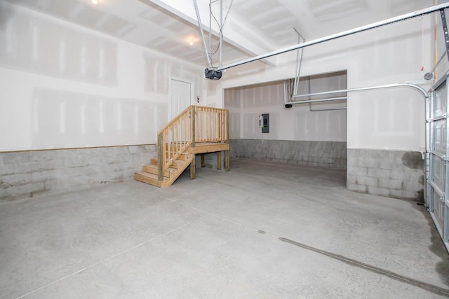 garage featuring electric panel and a garage door opener
