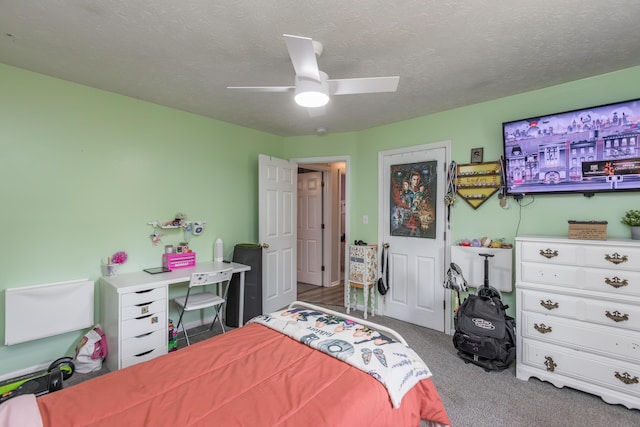 carpeted bedroom with a textured ceiling and ceiling fan