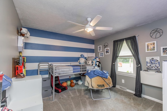 bedroom featuring visible vents, baseboards, a textured ceiling, a ceiling fan, and carpet