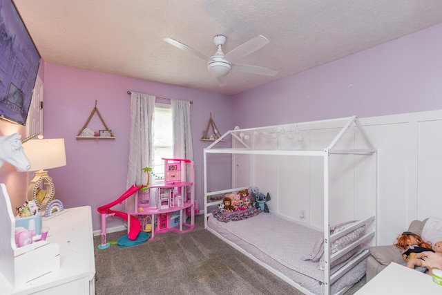 carpeted bedroom with ceiling fan and a textured ceiling