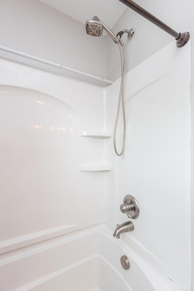 bathroom featuring a textured ceiling and shower / tub combination