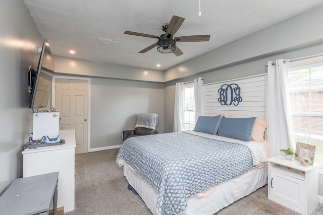 bedroom with a ceiling fan and light carpet