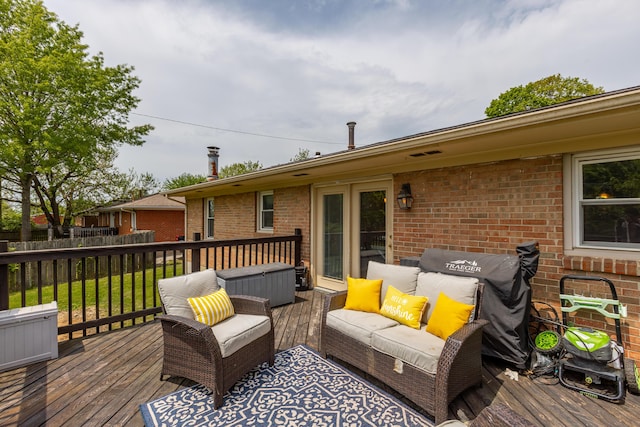 wooden terrace with fence and an outdoor living space