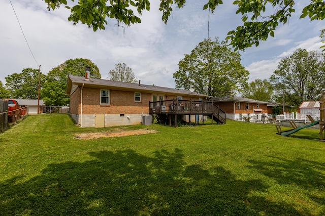 rear view of house with fence, brick siding, a wooden deck, stairway, and crawl space