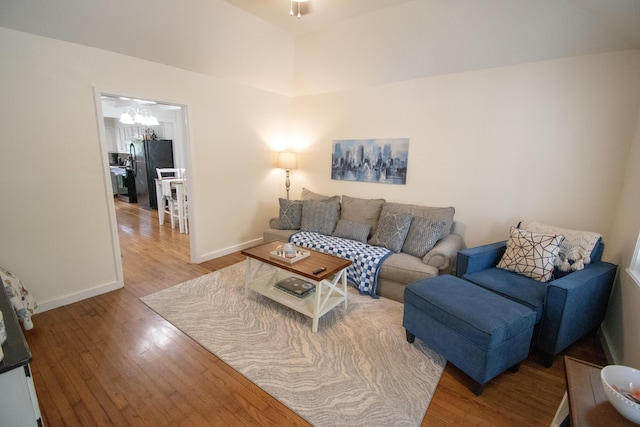 108 Central Ct, Richmond, KY 40475 - living area with wood finished floors, baseboards, and a chandelier